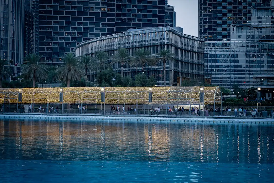 A large body of water surrounded by tall buildings — Photo by Usman Yousaf on Unsplash