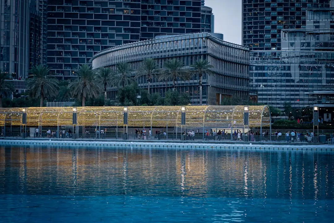 A large body of water surrounded by tall buildings — Photo by Usman Yousaf on Unsplash