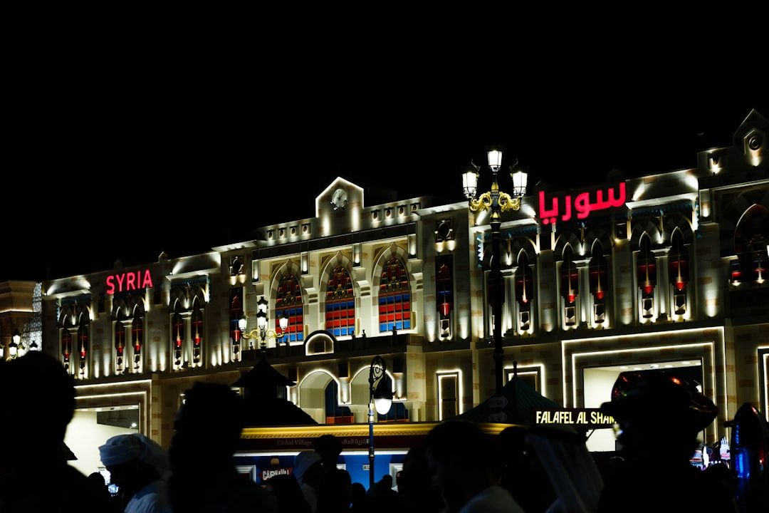 a building with many windows and lights — Photo by yasara hansani on Unsplash