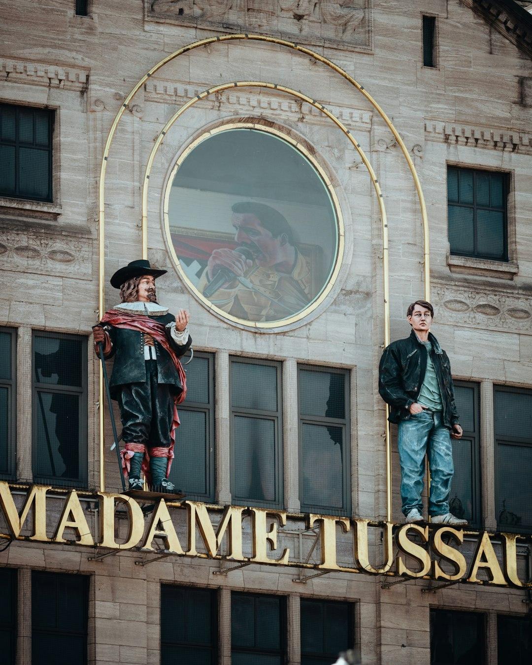 Two mannequins stand above madame tussauds sign. — Photo by Sara Ruffoni on Unsplash