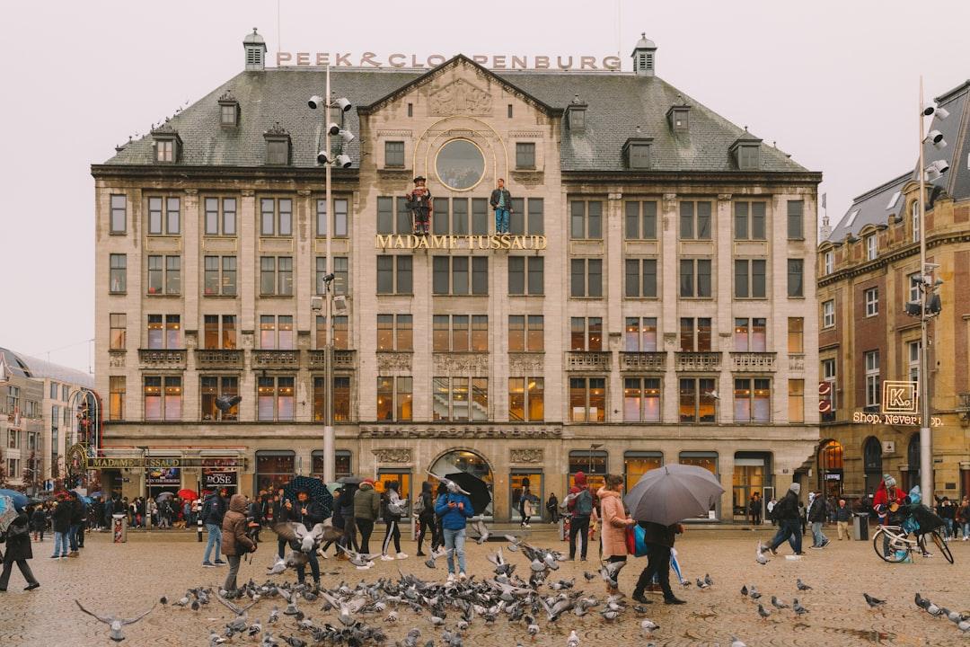 people walking around brown concrete building during daytime — Photo by Krisztian Tabori on Unsplash