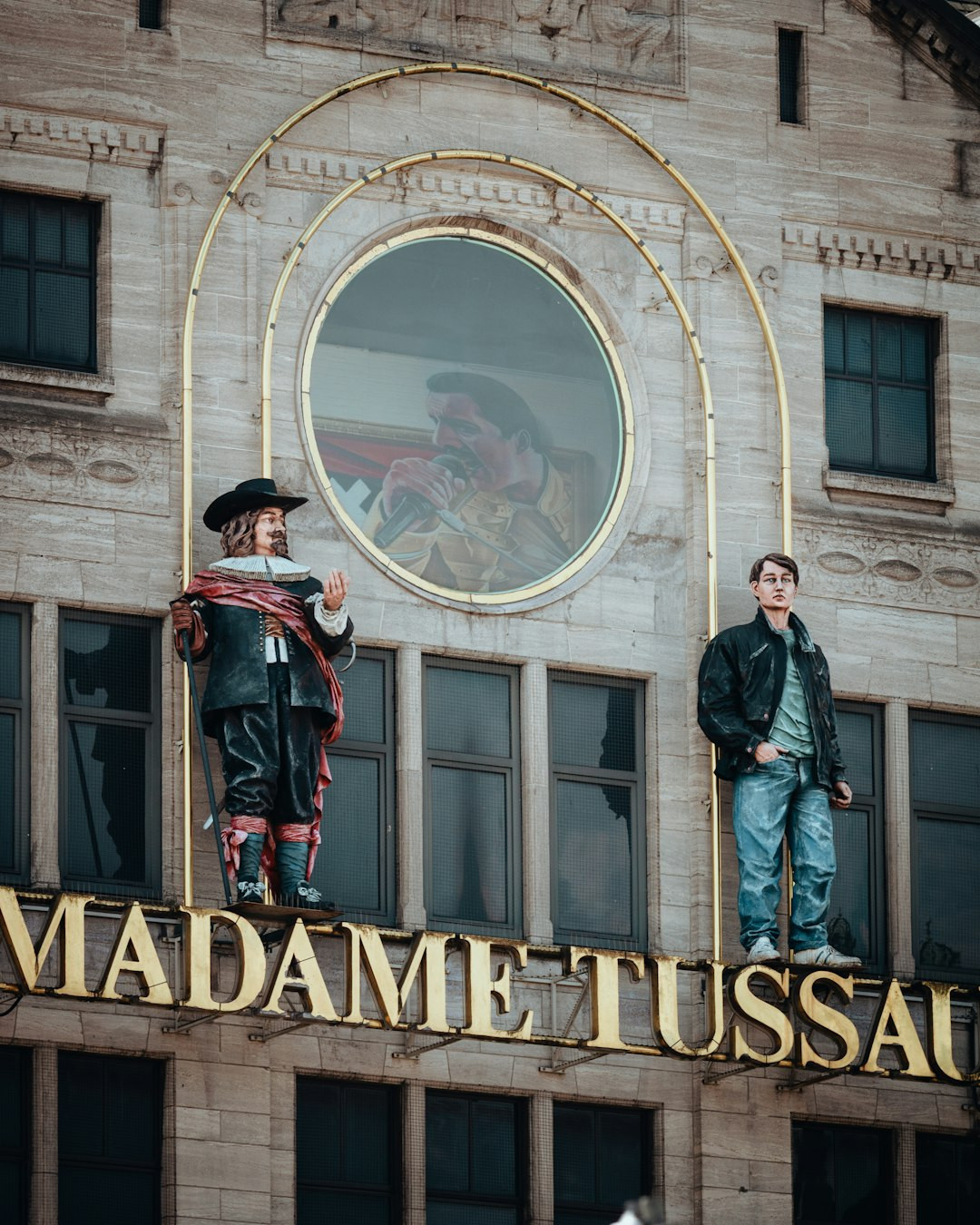 Two mannequins stand above madame tussauds sign. — Photo by Sara Ruffoni on Unsplash