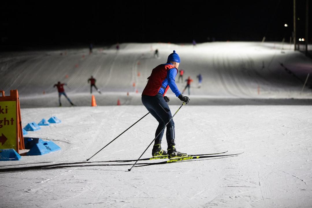 a man riding skis down a snow covered slope — Photo by Aaron Doucett on Unsplash