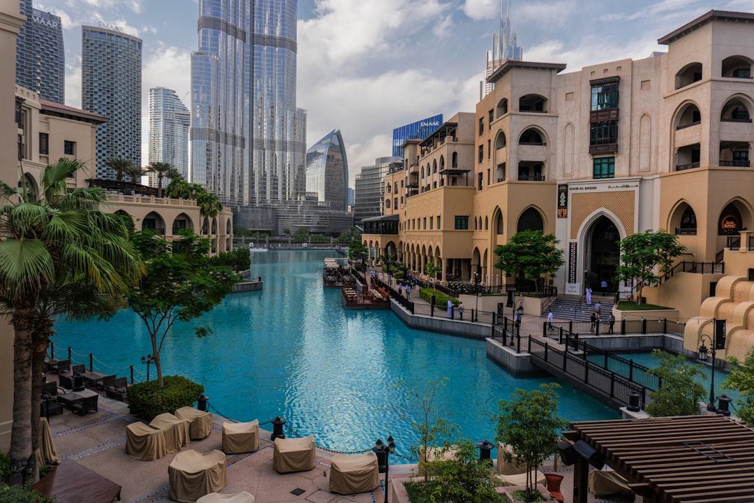 a large swimming pool surrounded by tall buildings — Photo by David Barros on Unsplash