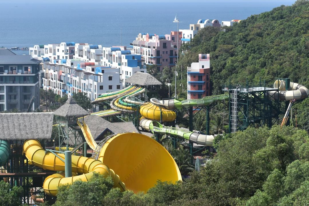 Water park with colorful slides on a green hillside. — Photo by Desiree M on Unsplash