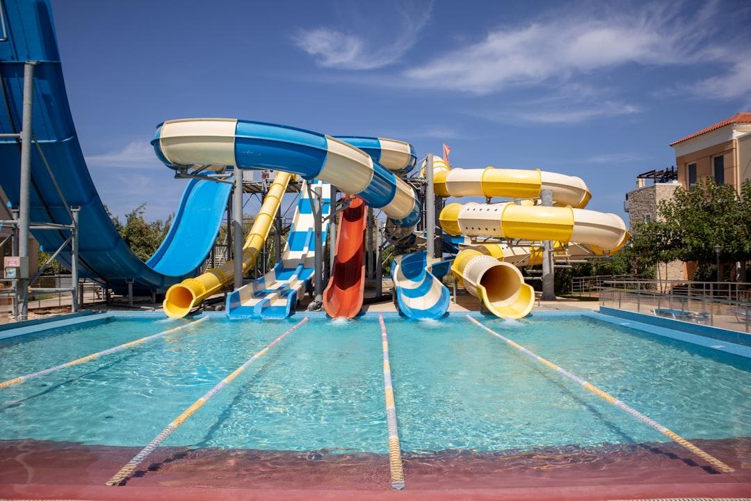 a water park with a water slide and slides — Photo by Konrad Burdyn on Unsplash