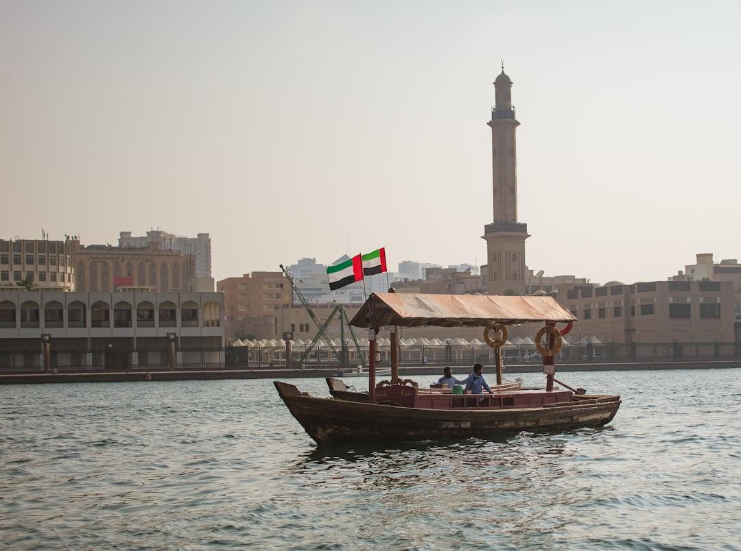 a boat with a flag on it in a body of water — Photo by Rodrigo Castro on Unsplash