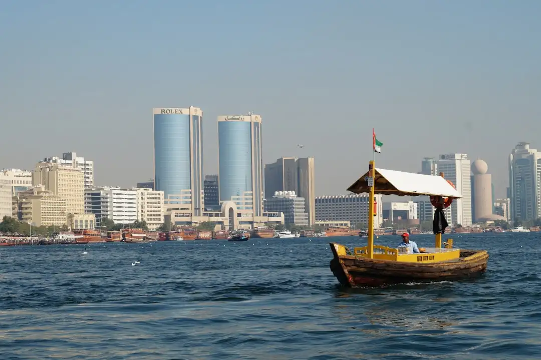 brown boat on body of water near city buildings during daytime — Photo by Swag Photography on Unsplash