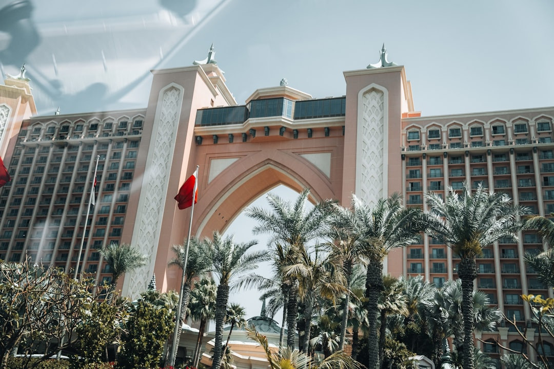 A large building with a clock tower in front of it — Photo by Nejc Soklič on Unsplash