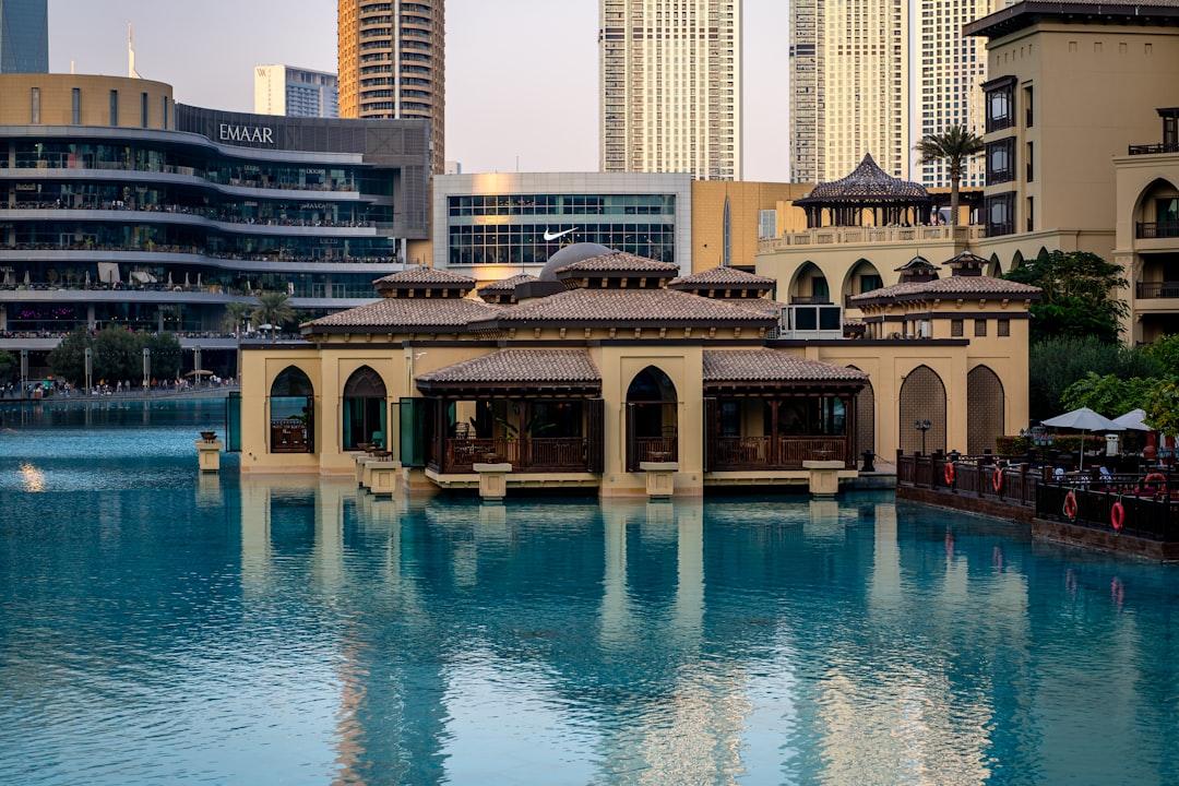 A large body of water surrounded by tall buildings — Photo by Usman Yousaf on Unsplash