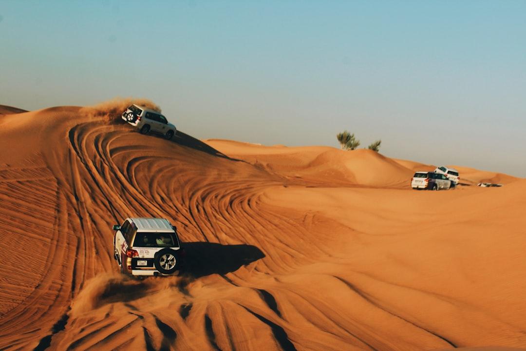 vehicles on desert during daytime — Photo by Alina Grubnyak on Unsplash
