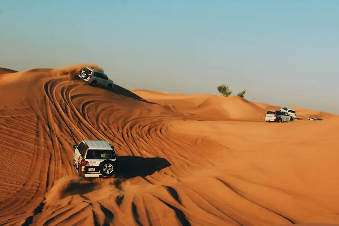 vehicles on desert during daytime — Photo by Alina Grubnyak on Unsplash