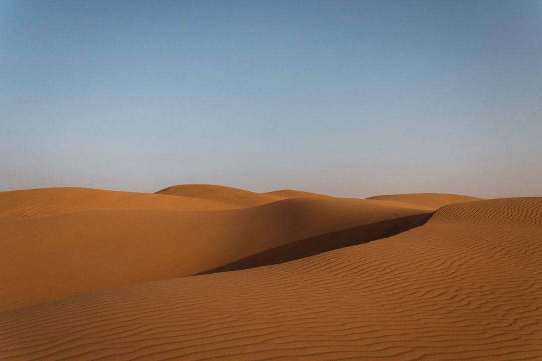 a vast expanse of sand in the desert — Photo by Daniel Buhat on Unsplash