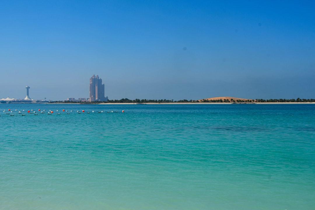 a large body of water with a tall building in the background — Photo by SnapSaga on Unsplash