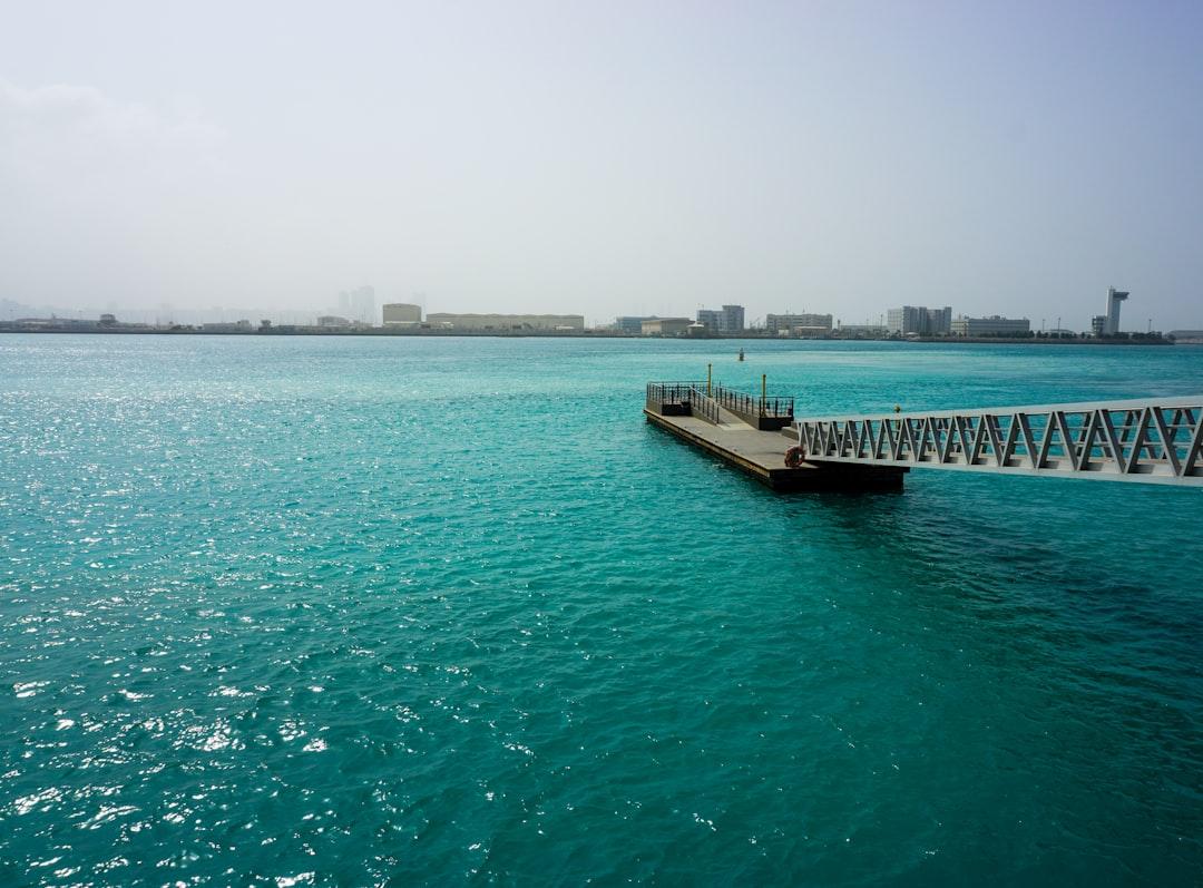 A pier extends into beautiful turquoise water. — Photo by Sergio Sierra on Unsplash