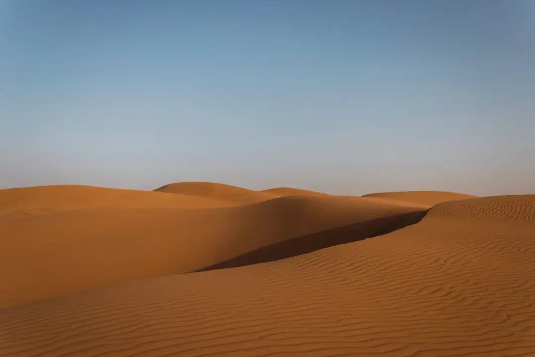 a vast expanse of sand in the desert — Photo by Daniel Buhat on Unsplash