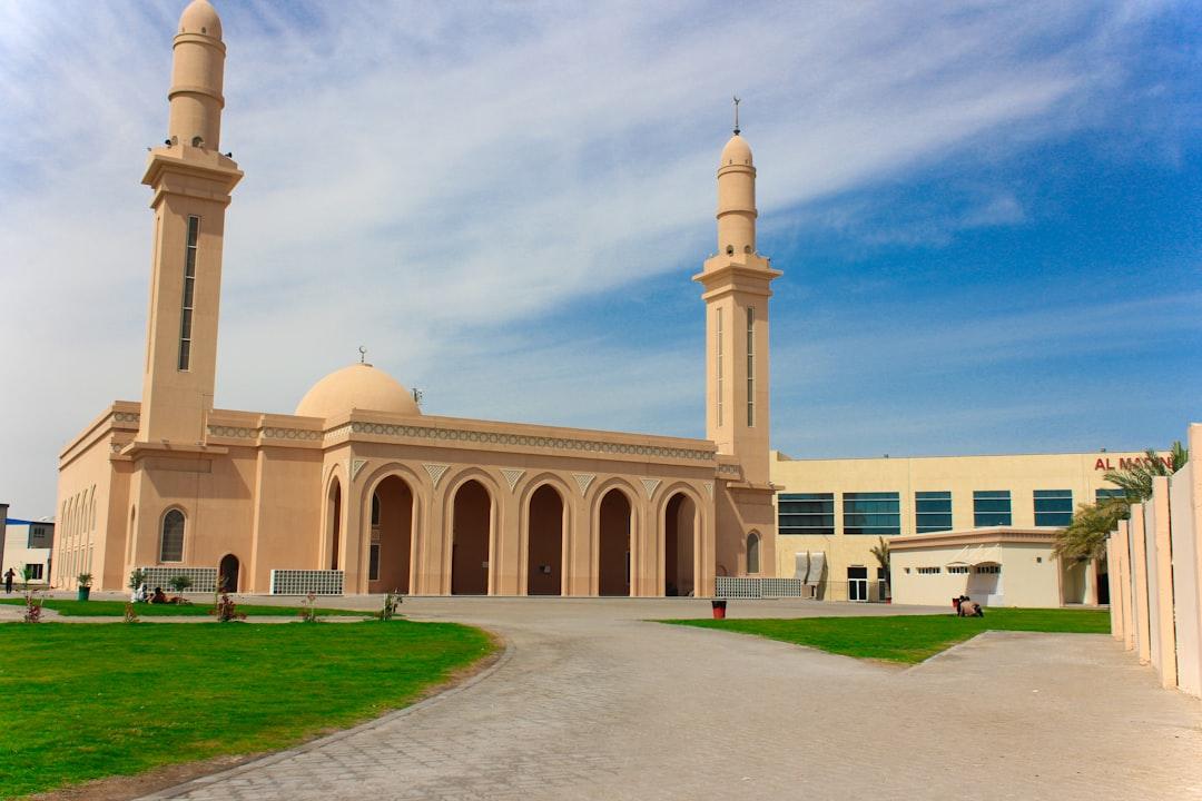 a large beige building with two tall towers — Photo by Nithin Purple on Unsplash