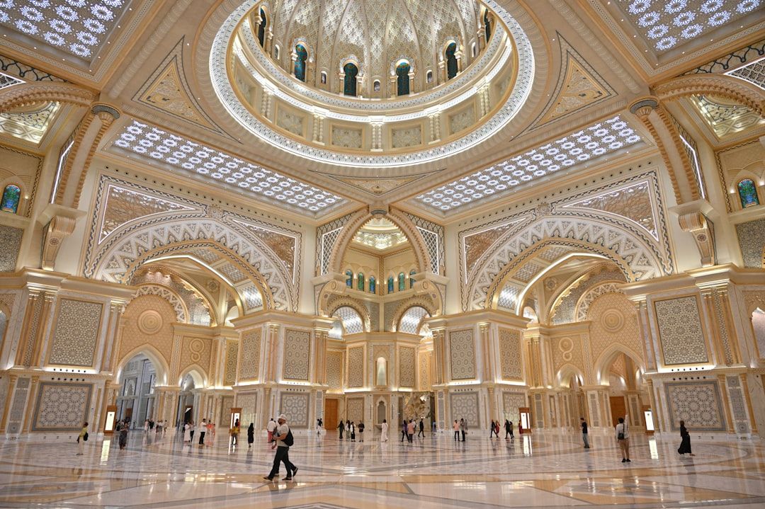 Ornate interior of a grand palace with people walking — Photo by Po-Hsuan Huang on Unsplash