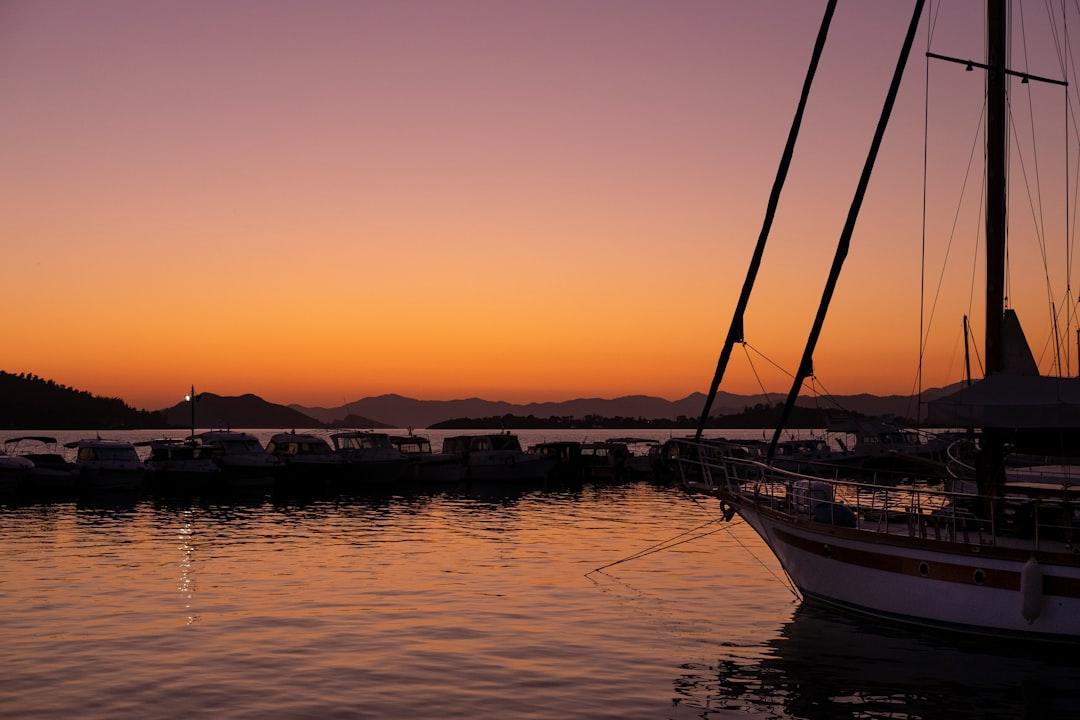 a sailboat is docked in the water at sunset — Photo by Valeriia Bugaiova on Unsplash