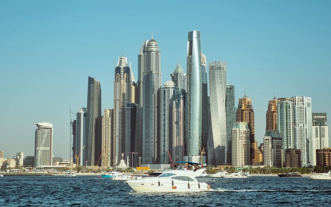 A boat in a body of water with a city in the background — Photo by Rushikesh Patil on Unsplash