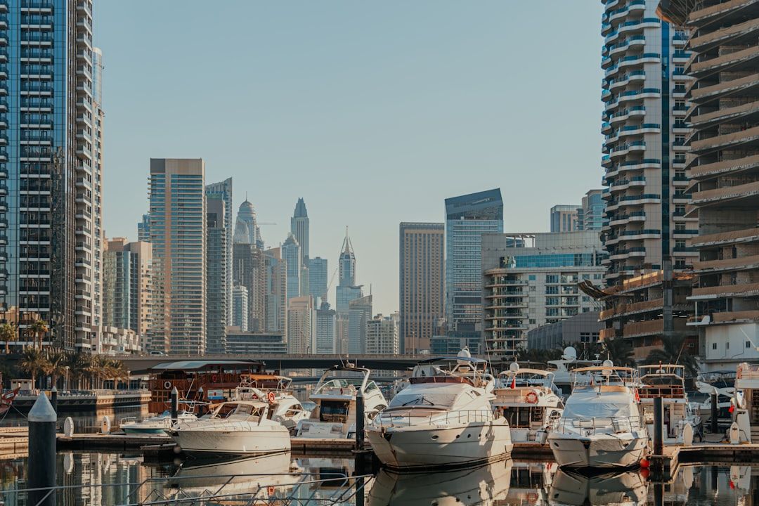A harbor filled with lots of boats next to tall buildings — Photo by Kate Trysh on Unsplash