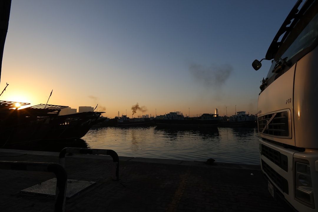 Sunrise over a harbor with boats and truck — Photo by Jef Galas on Unsplash