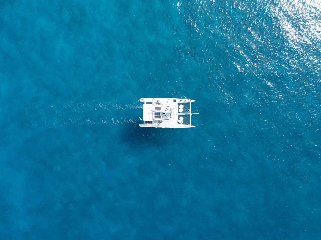 A boat glides across the deep blue ocean. — Photo by User_Pascal on Unsplash