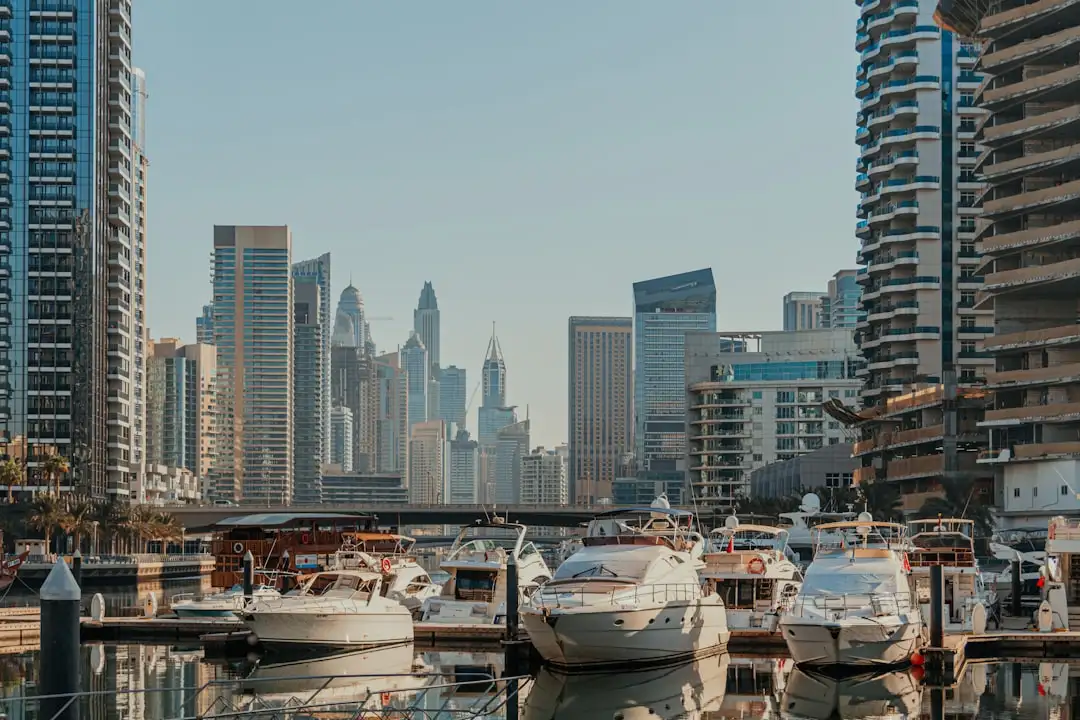 A harbor filled with lots of boats next to tall buildings — Photo by Kate Trysh on Unsplash