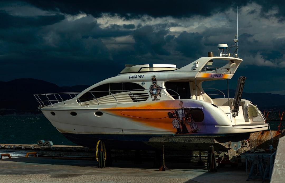 A luxury yacht docked under a stormy sky — Photo by Stepan Konev on Unsplash
